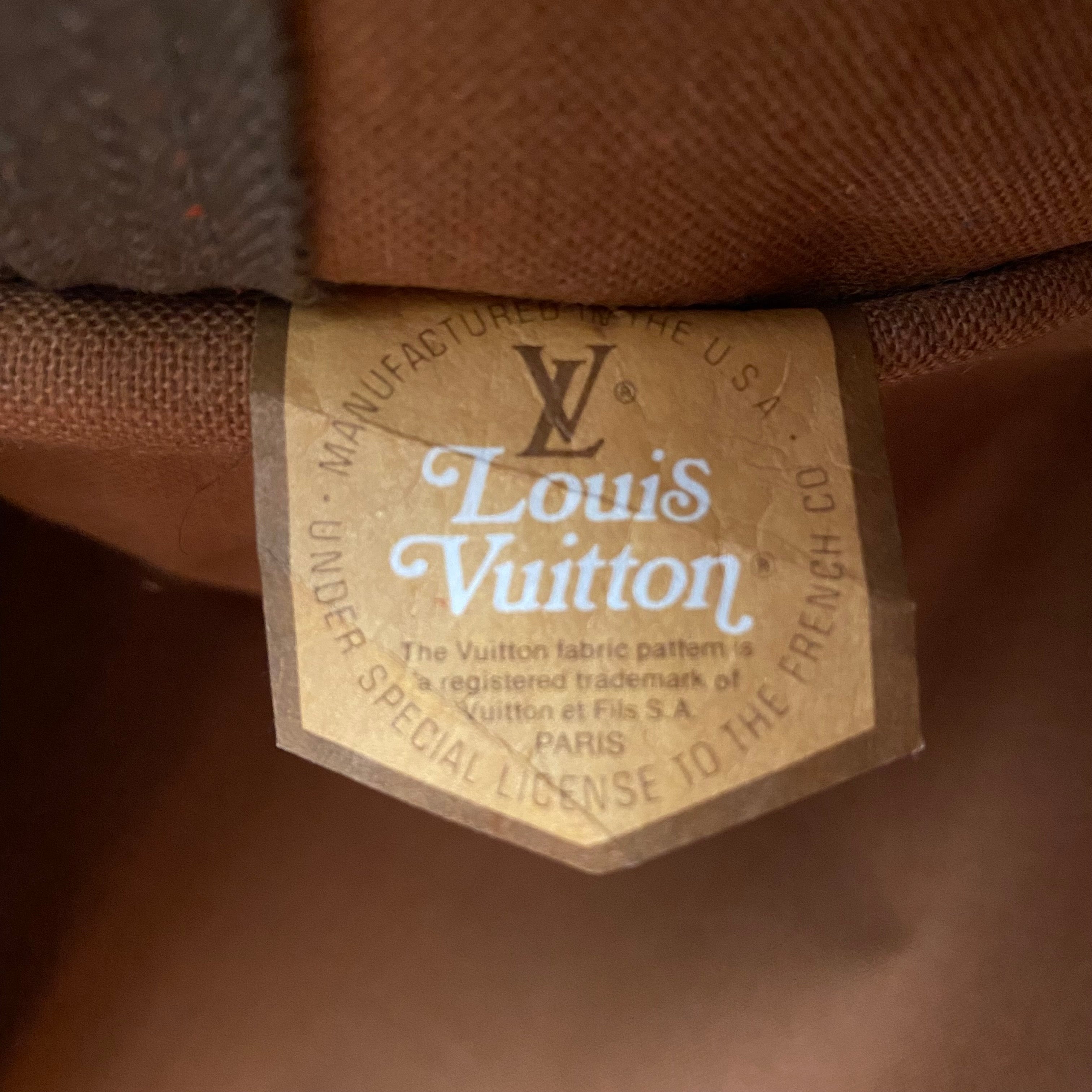 Lot - A GROUP OF TWO FRENCH LUGGAGE CO. LOUIS VUITTON COATED CANVAS AND  LEATHER HANGING GARMENT BAGS, UNITED STATES, CIRCA 1970-1985